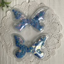 Силиконовая бабочка с наполнителем, 7х4,5 см, светло-синие перламутровые цветочки, упаковка 20 шт. Силиконовая бабочка с наполнителем, 7х4,5 см, светло-синие перламутровые цветочки, упаковка 20 шт.