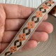 Жакард-вышиванка (ТВ-№33), 1,7 см, бежевый с оранжево-коричневым орнаментом, рулон 45 м Жакард-вышиванка (ТВ-№33), 1,7 см, бежевый с оранжево-коричневым орнаментом, рулон 45 м